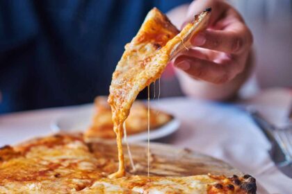 Eating grated cheese pizza.