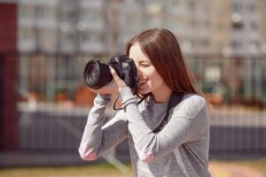 Female photographer taking outdoor pictures.
