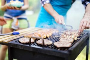 Putting meat in the BBQ.