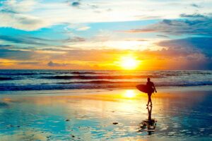 Surfing at sunset in Indonesia.