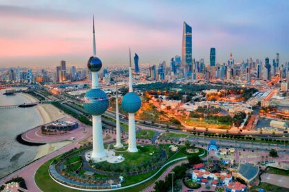 Kuwait Tower City Skyline glowing at night.