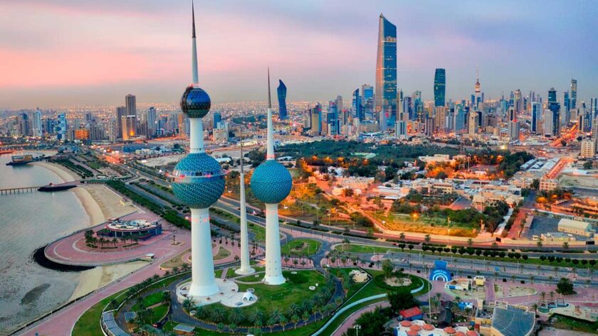 Kuwait Tower City Skyline glowing at night.