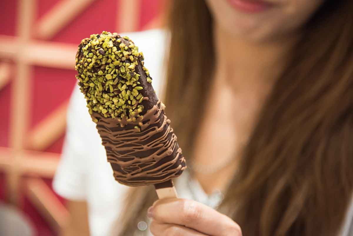 Chocolate popsicle with pistachios.