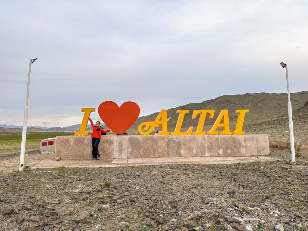 traveler posing with the "I Love Altai" sign