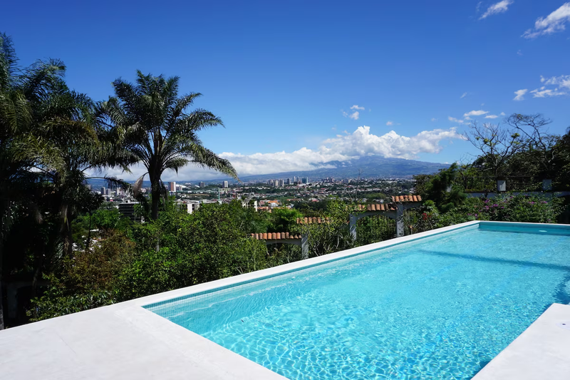 pool with a view of the mountains at the Posada El Quijote Vegan Resort in Costa Rica
