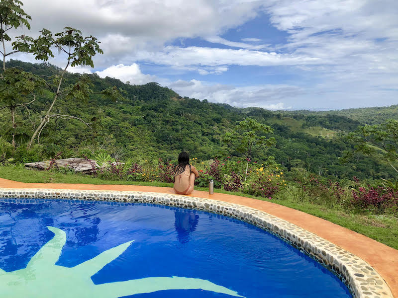 woman taking in panoramic views from the pool at Farm of Life Vegan Resort in Costa Rica