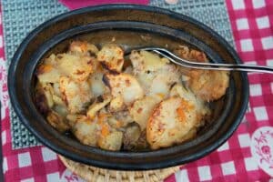 black bowl filled with Baeckeoffe, a traditional Strasbourg food