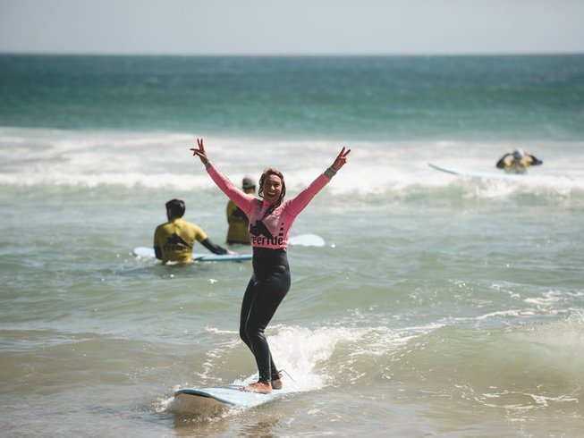woman surfing with her hands in the air
