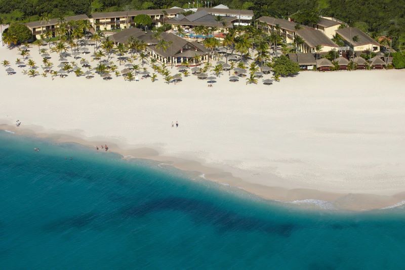 water lapping up onto the shores of the vegan-friendly Manchebo Beach Resort and Spa in the Caribbean