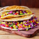 traveler eating plant-based tacos at a vegan resort in the Caribbean