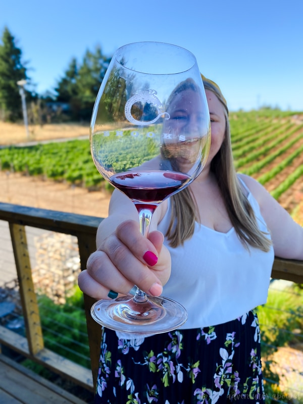 woman drinking wine at one of the many biodynamic wineries in Oregon