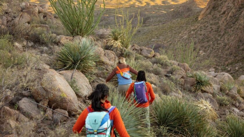 women hiking while wearing Cotopaxi gear that gives back