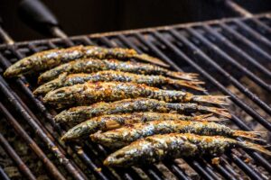Freshly grilled sardines on the grill.
